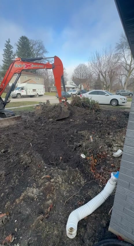 Maximum excavator digging residential front yard